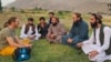 A German tourist talks to local residents and Taliban officials in the northern province of Panjshir.