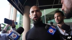 Andrew Tate speaks to journalists at the Fort Lauderdale airport on February 27.