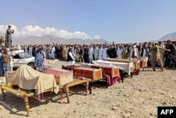 Sunni Muslim men gather to offer prayers during the funeral ceremony for victims who were killed in a sectarian clash in the northwestern district of Kurram on October 13.