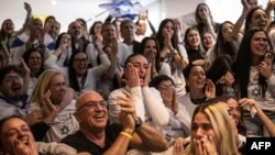 Dana Shem Tov (center) the sister of Israeli hostage Omer Shem Tov reacts as she watches with others his televised release by Hamas militants at the family home in Tel Aviv on February 22.