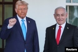 U.S President Donald Trump welcomes Israeli Prime Minister Benjamin Netanyahu at the entrance of the White House in Washington, February 4