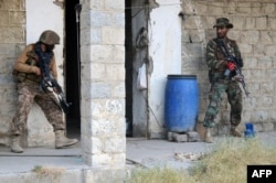 Pakistani soldiers take positions as they search a house during a military operation against Taliban militants in the North Waziristan district. (file photo)