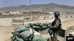 An Afghan soldier keeps watch at the gate of the air force compound near Kabul.