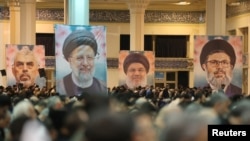 Banners of Iran's late President Ebrahim Raisi and key figures of the 'axis of resistance' are displayed during a ceremony in Tehran on January 2.